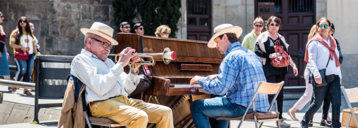 man playing the trumpet and man playing piano outdoors