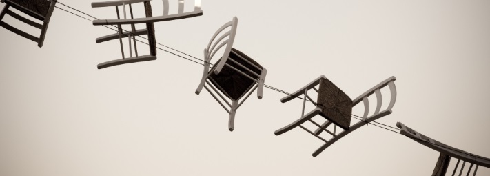 wooden chairs flying through the air