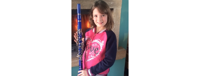 Aimée with her clarinet at her home 