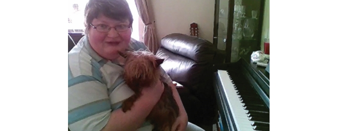 Online piano student Rebecca with her dog Toby