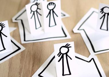 cutout paper figures and households assembled with social distance measures
