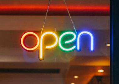 neon rainbow open sign in door window