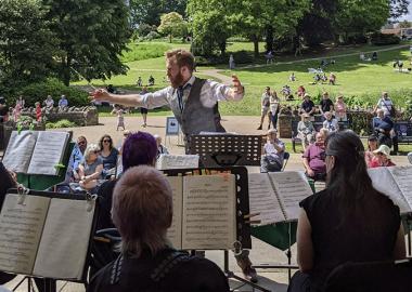 music director conducting wind band outdoor