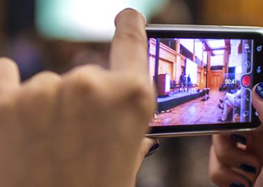 person taking video of a rehearsal on a smartphone